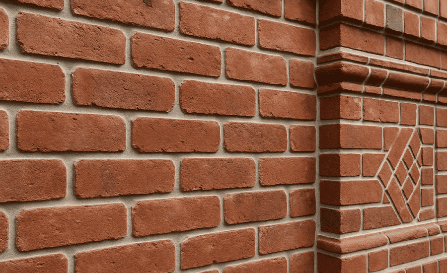 Decorative brick wall with sharp V-pointing mortar joints enhancing durability and visual appeal in masonry.