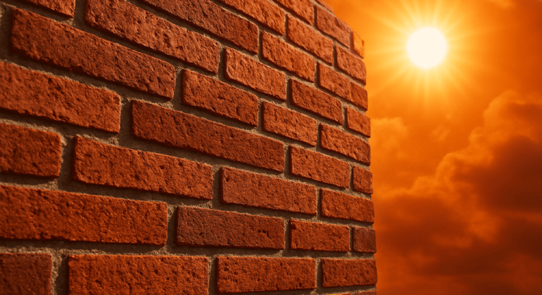 Brick pointing work on masonry wall in extreme hot weather, showing mortar joints affected by heat