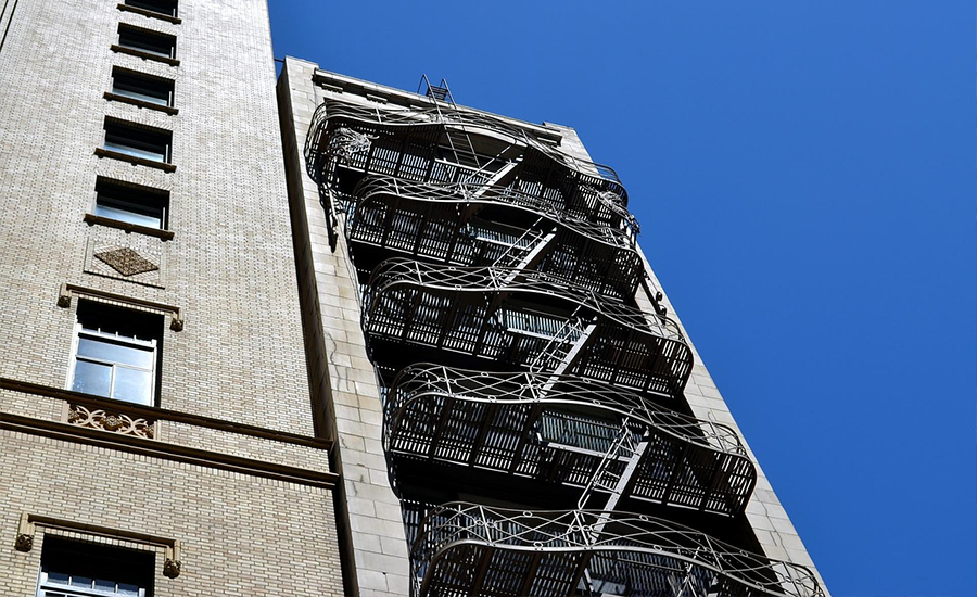 Metal fire escape on a classic Brooklyn building showing strong steel structure, safety design, and architectural charm under natural daylight.