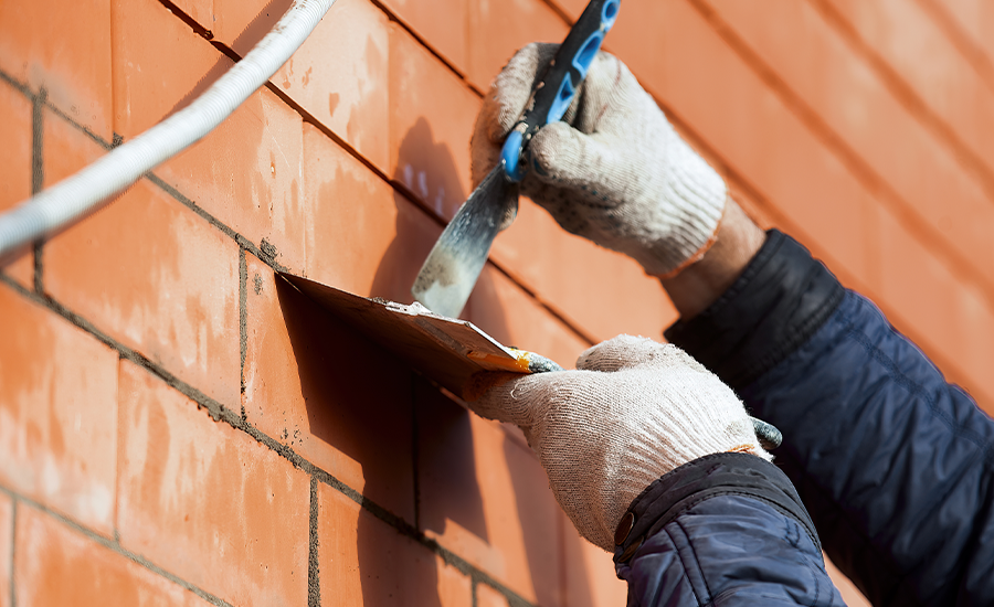 Brick repointing during cold weather using winter-grade mortar and protective covers in NYC