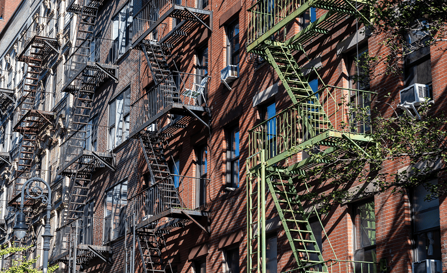 Fire escapes on historic New York buildings showing classic metal staircases across brick façades.