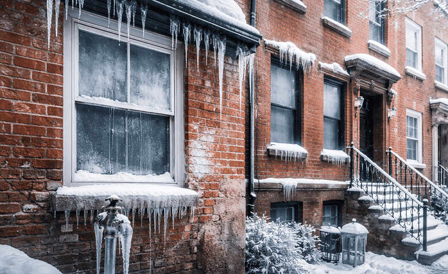 Winter moisture damage on brick homes in NYC, showing ice buildup, frozen window sills, and exterior dampness