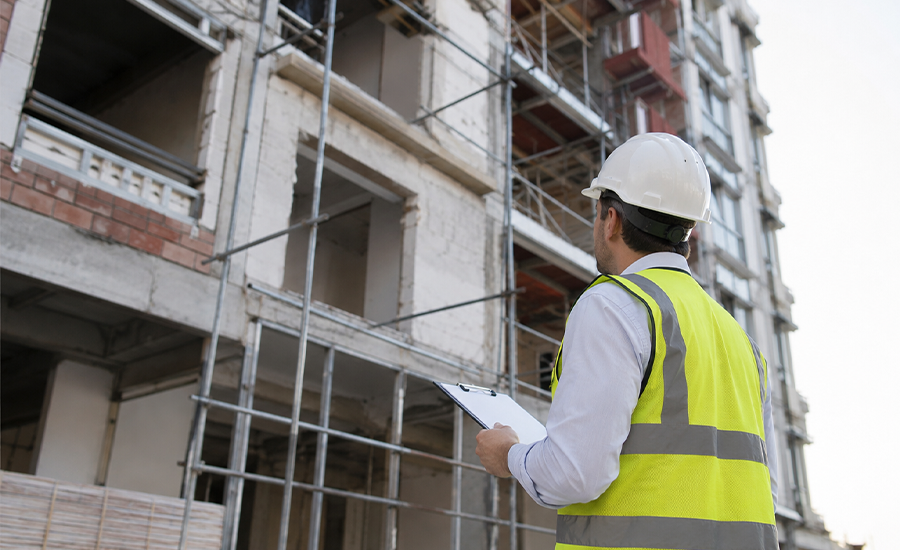 NYC building inspector reviewing an aging brick property with facade damage and fire escape safety concerns