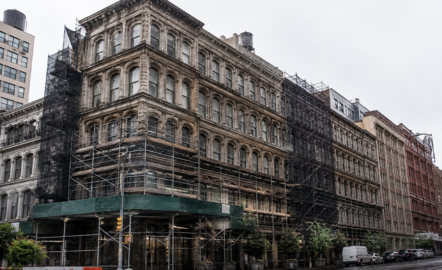 historic building restoration in NYC with large facade under scaffolding and detailed architectural work