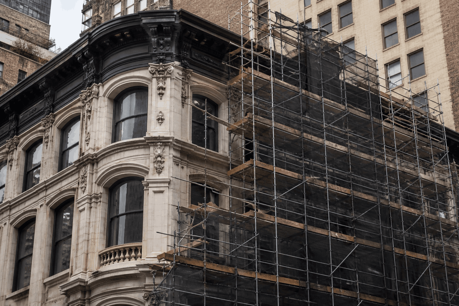historic building restoration in NYC with scaffolding on facade and detailed exterior repair work historic building restoration in NYC with scaffolding on facade and detailed exterior repair work