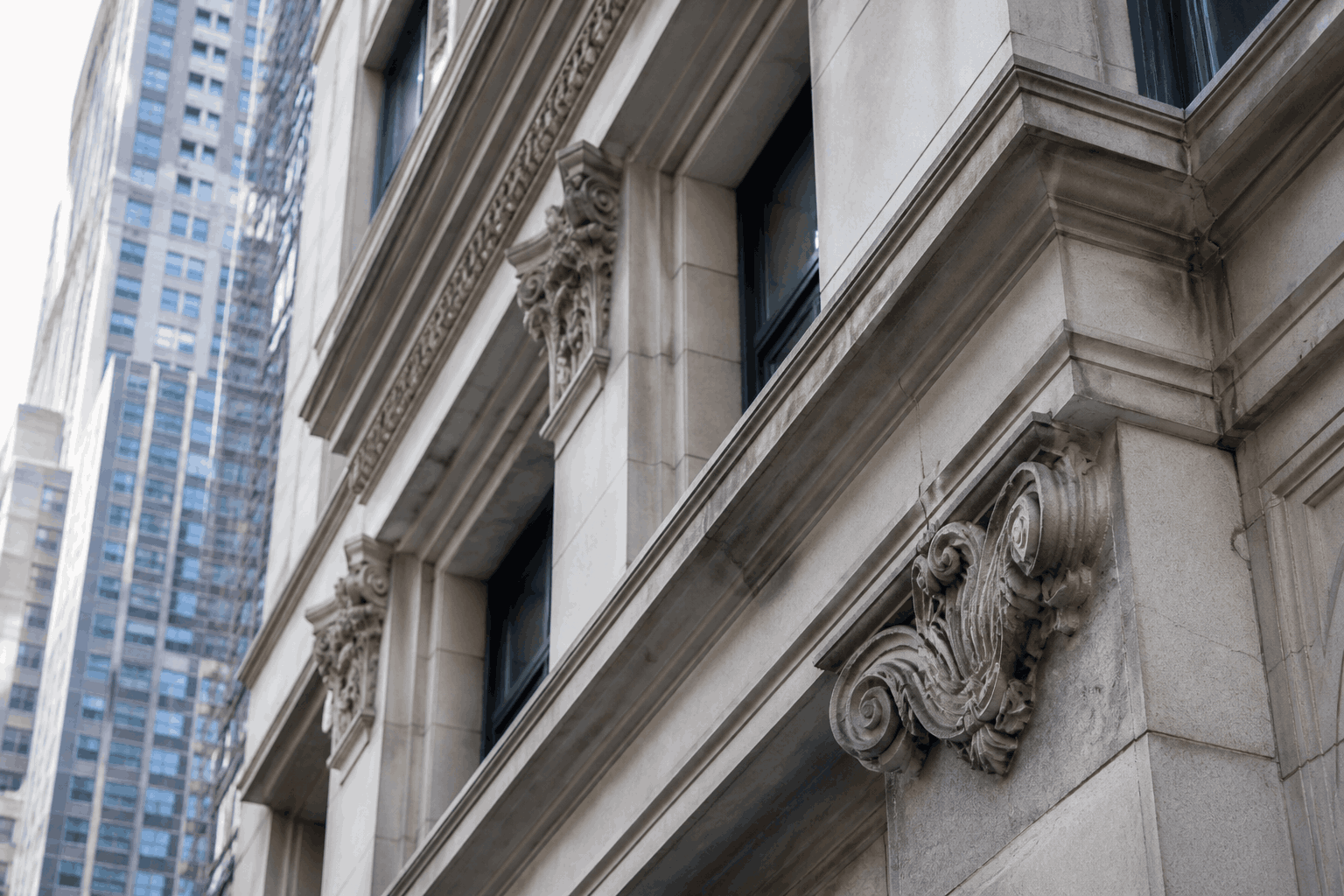 well-maintained stone building facade with detailed architectural elements in NYC well-maintained stone building facade with detailed architectural elements in NYC