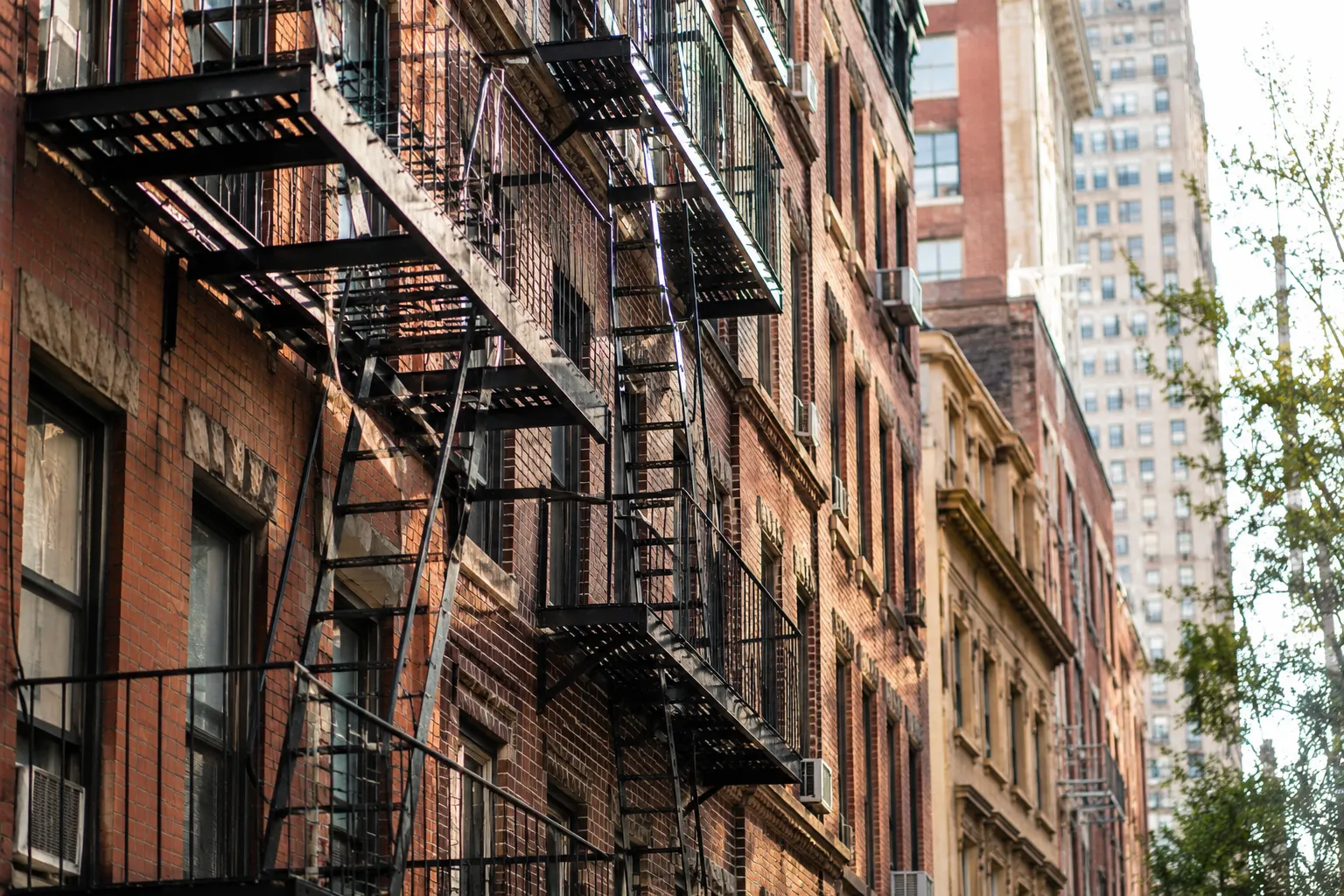 Exterior fire escapes installed on brick apartment buildings in New York City Exterior fire escapes installed on brick apartment buildings in New York City