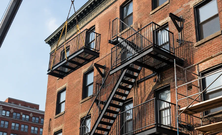 Newly installed exterior fire escape on a brick building in New York City